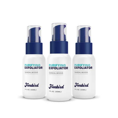 Three 1 fl. oz. bottles of Freebird Purifying Scalp Exfoliating Scrub, sandalwood scent, for removing dead skin cells and flaky patches, with blue caps.