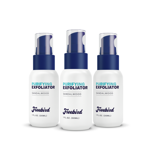 Three 1 fl. oz. bottles of Freebird Purifying Scalp Exfoliating Scrub, sandalwood scent, for removing dead skin cells and flaky patches, with blue caps.